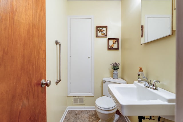 5200 N Jennings Rd, Flint, MI 48504 - half bathroom with toilet, a sink, and baseboards