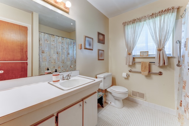 5200 N Jennings Rd, Flint, MI 48504 - full bath featuring toilet, tile patterned floors, vanity, and baseboards