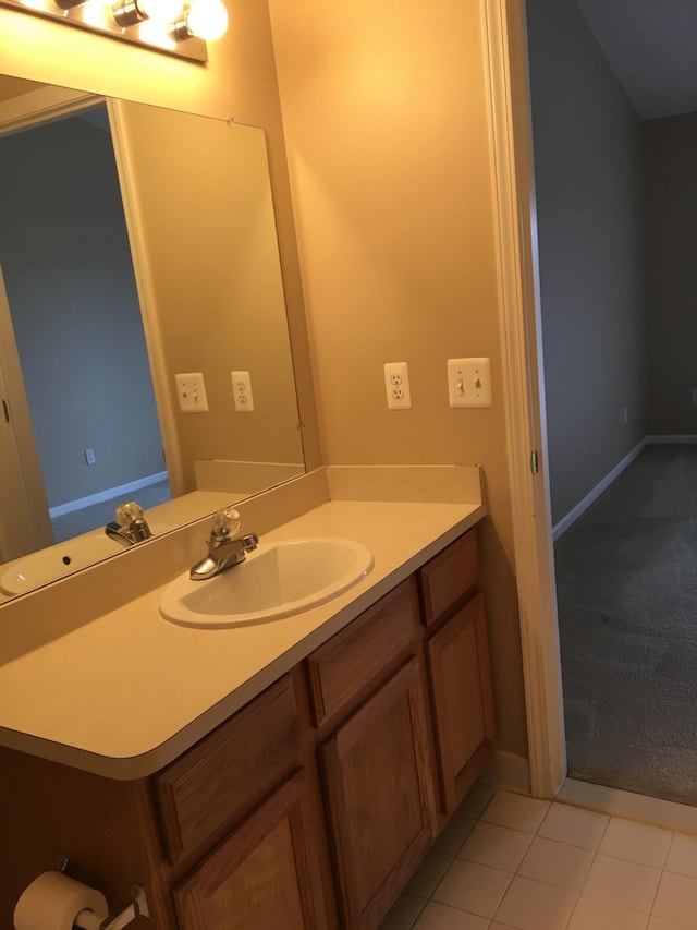 bathroom with vanity, baseboards, and tile patterned floors