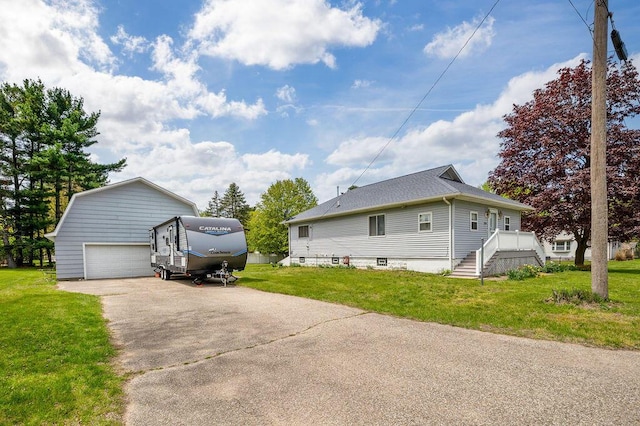 220 S Berrien St, New Buffalo, MI 49117 - view of side of home featuring an outdoor structure, asphalt driveway, and a yard