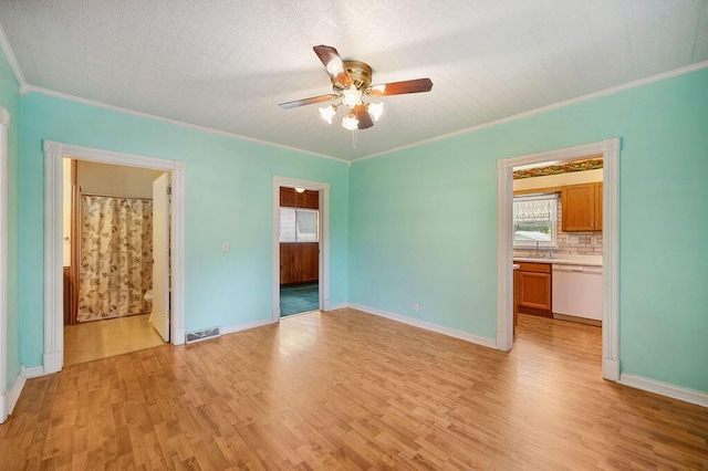 220 S Berrien St, New Buffalo, MI 49117 - empty room featuring a ceiling fan, light wood-style floors, ornamental molding, a sink, and baseboards