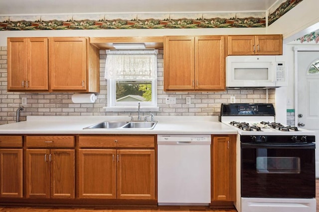 220 S Berrien St, New Buffalo, MI 49117 - kitchen with white appliances, a sink, light countertops, and backsplash