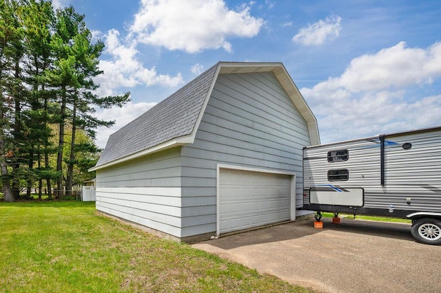 220 S Berrien St, New Buffalo, MI 49117 - view of home's exterior with a shingled roof, an outdoor structure, a yard, a garage, and a gambrel roof