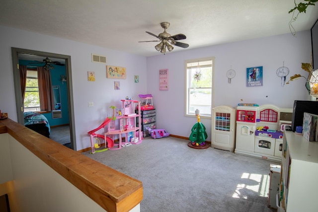 game room with a ceiling fan, carpet flooring, and baseboards