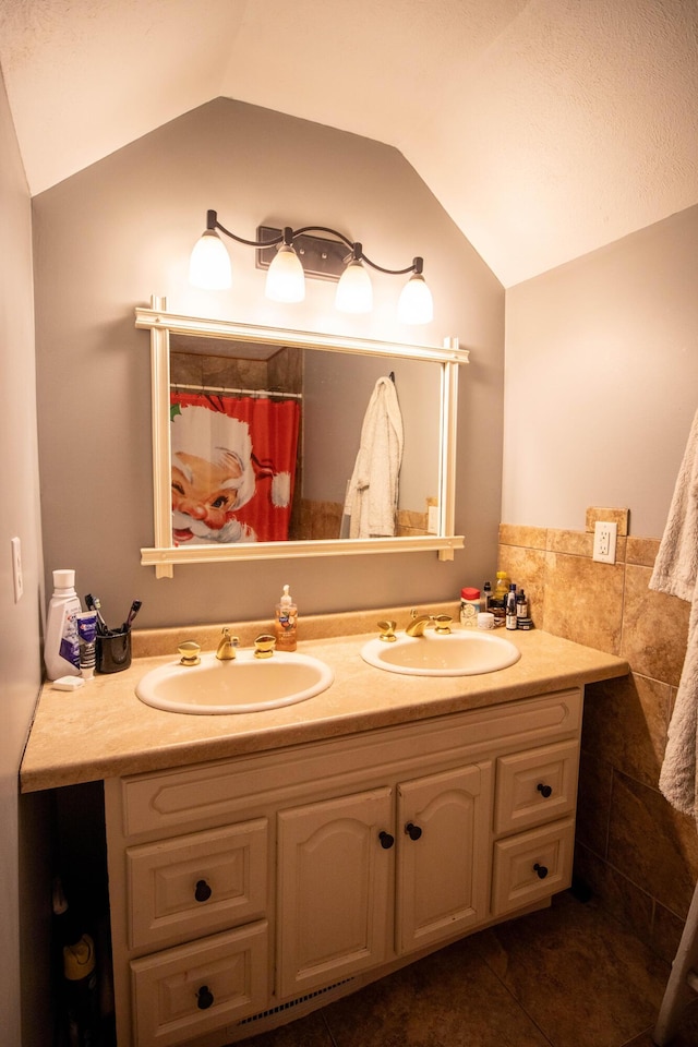 full bathroom featuring vaulted ceiling and double vanity