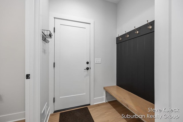 mudroom with light wood finished floors and baseboards