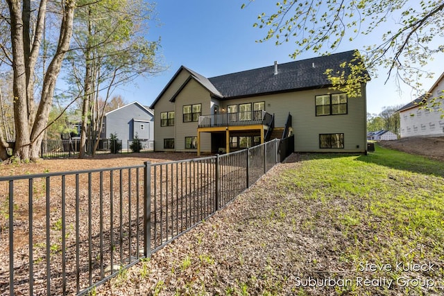 back of house with a wooden deck and a fenced backyard