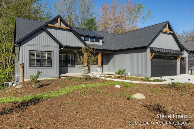 modern farmhouse with a porch, an attached garage, roof with shingles, central air condition unit, and driveway