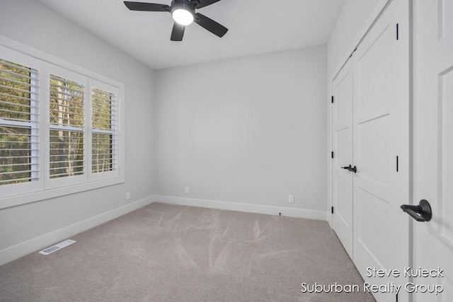 unfurnished bedroom with baseboards, carpet floors, a closet, and a ceiling fan