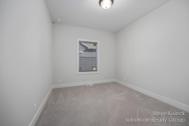 empty room with carpet floors and baseboards
