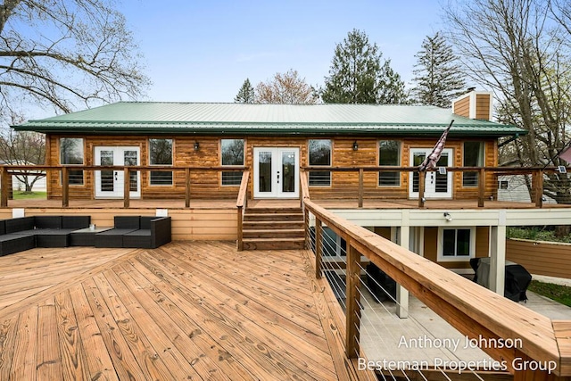 wooden terrace with french doors and an outdoor living space