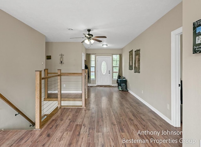 entrance foyer featuring wood finished floors, a ceiling fan, and baseboards