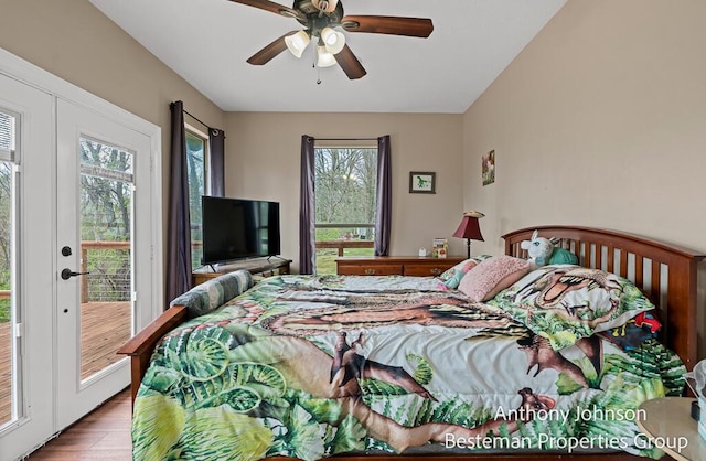 bedroom featuring access to outside, wood finished floors, and a ceiling fan