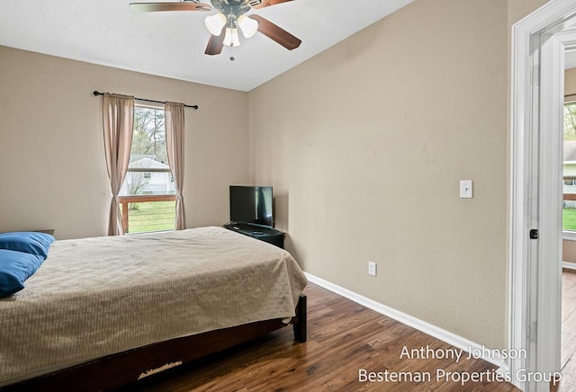 bedroom with wood finished floors, baseboards, and ceiling fan