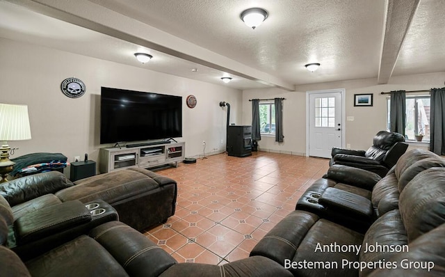 tiled living area featuring a textured ceiling, baseboards, beamed ceiling, and a wood stove