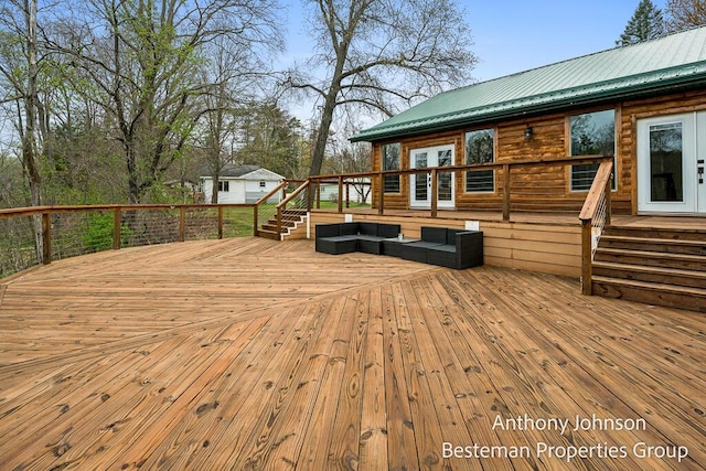 deck featuring an outdoor living space and french doors