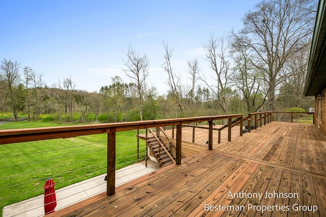 wooden terrace with a lawn