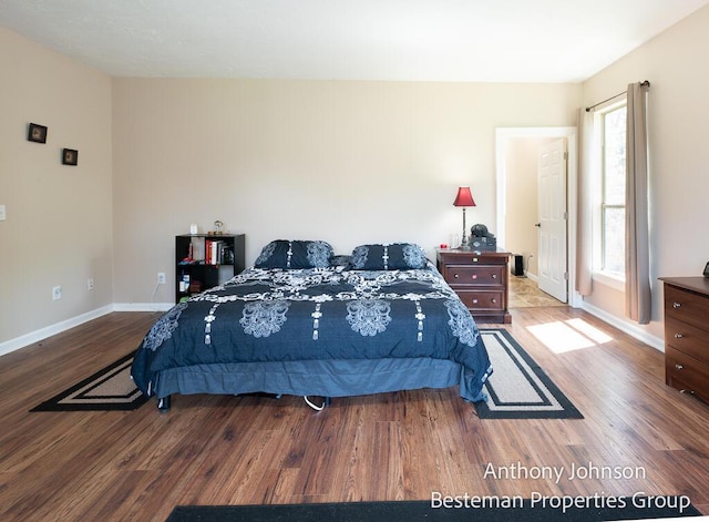 bedroom featuring wood finished floors and baseboards