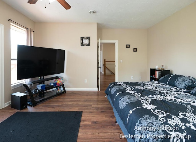 bedroom featuring wood finished floors, baseboards, and a ceiling fan