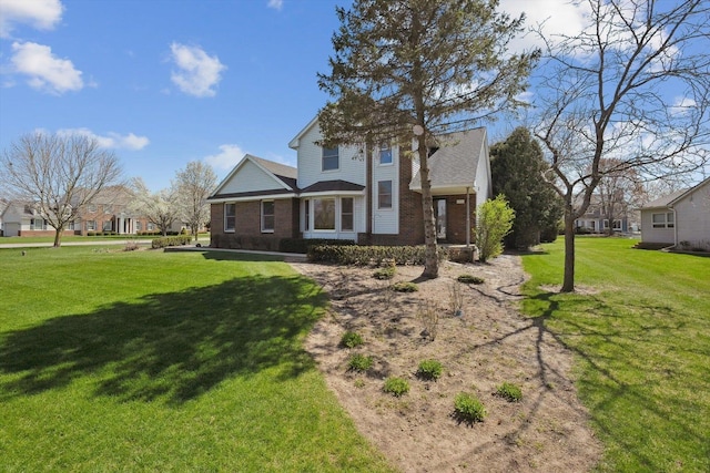 view of front of home with brick siding and a front yard