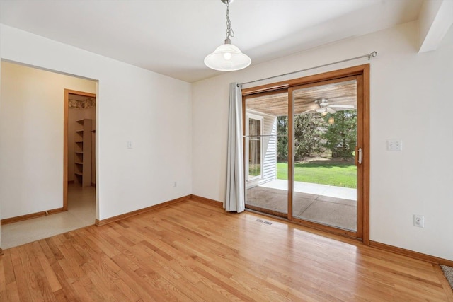 spare room with light wood-style flooring, baseboards, and ceiling fan
