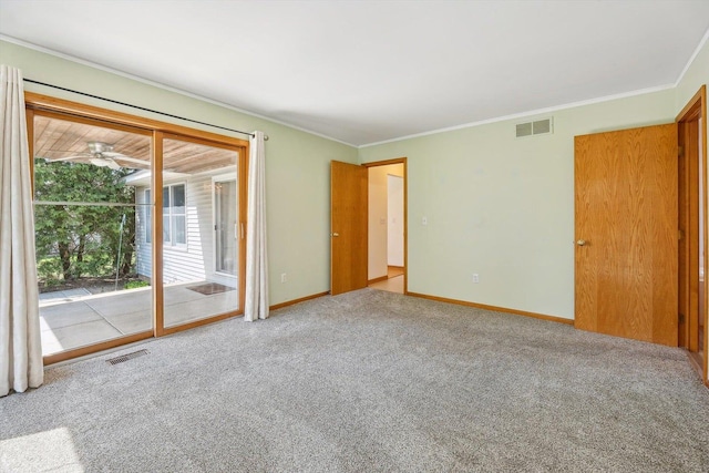 carpeted spare room with crown molding and baseboards