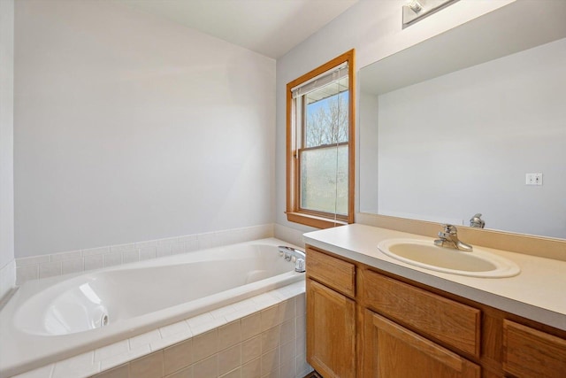 full bath featuring a garden tub and vanity