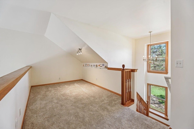 additional living space featuring carpet flooring, baseboards, and vaulted ceiling