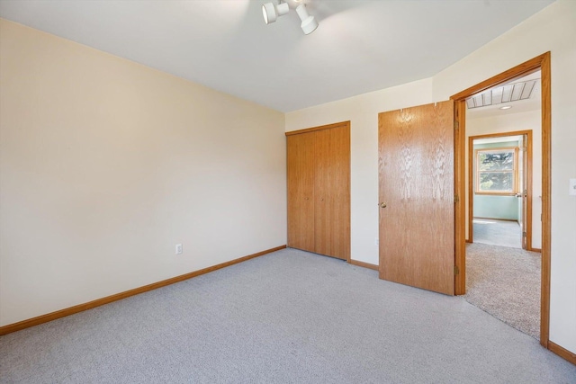 unfurnished bedroom featuring carpet and baseboards