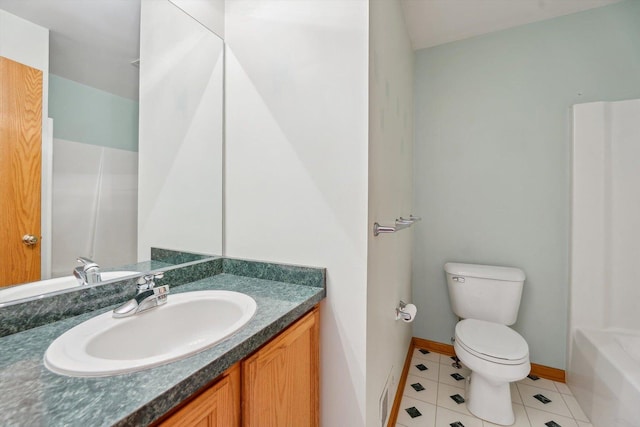 bathroom featuring toilet, baseboards, tile patterned floors, vanity, and a shower