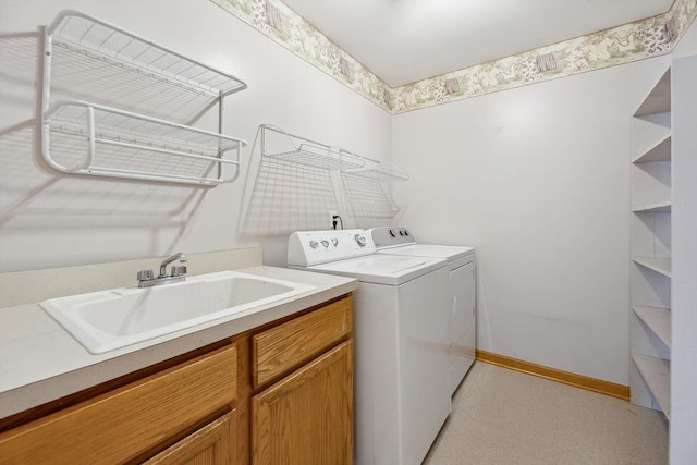 washroom with washing machine and dryer, baseboards, and cabinet space