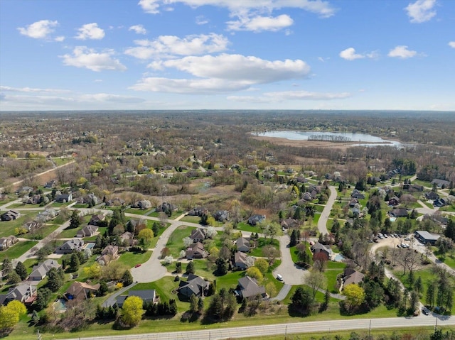 aerial view of residential area featuring a large body of water