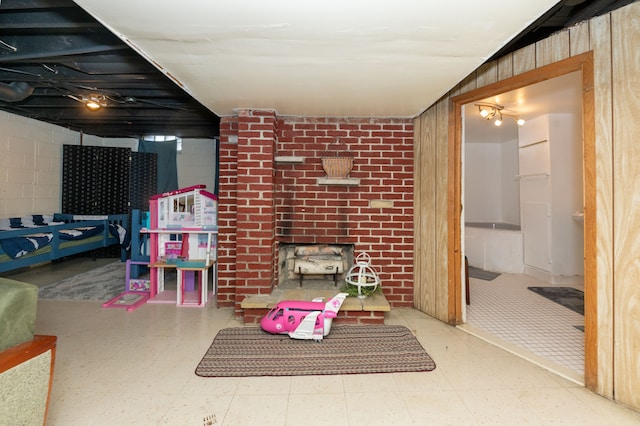 4941 Julius Blvd, Westland, MI 48186 - finished basement with tile patterned floors, a brick fireplace, and wooden walls