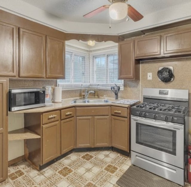 4941 Julius Blvd, Westland, MI 48186 - kitchen with appliances with stainless steel finishes, a sink, light countertops, and a ceiling fan