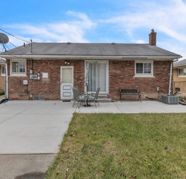 4941 Julius Blvd, Westland, MI 48186 - back of house featuring entry steps, a chimney, brick siding, and a lawn