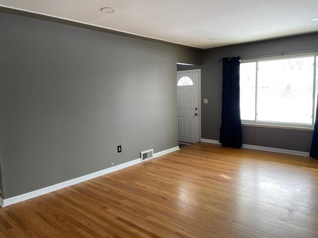 empty room featuring wood finished floors and baseboards