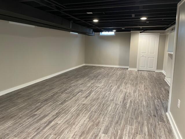 below grade area with wood finished floors and baseboards