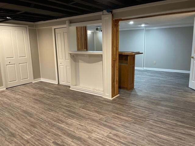 finished basement featuring baseboards and dark wood-style flooring