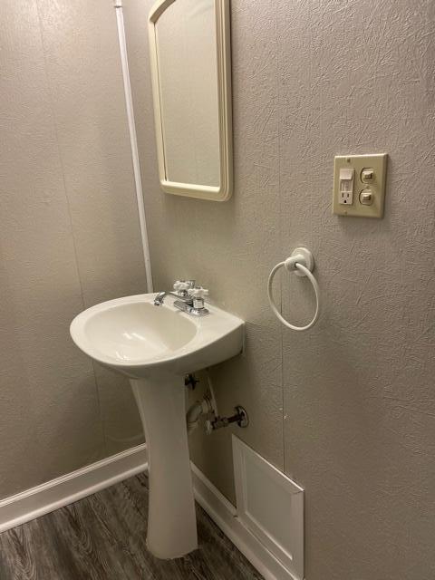 bathroom featuring wood finished floors and baseboards