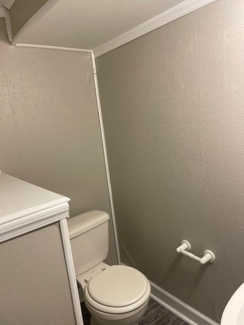 bathroom featuring toilet and wood finished floors