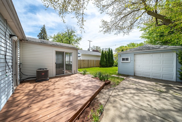deck with cooling unit, an outbuilding, driveway, and a garage