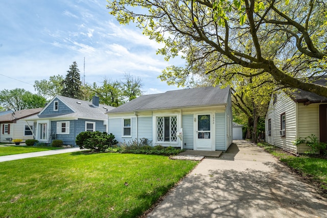 view of front of home with a front lawn and an outdoor structure