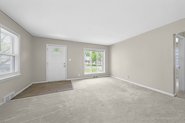 carpeted foyer entrance with baseboards