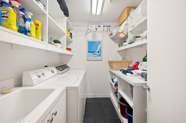50102 Alpine Blvd, New Buffalo, MI 49117 - laundry room with washer and clothes dryer, cabinet space, dark tile patterned floors, and baseboards