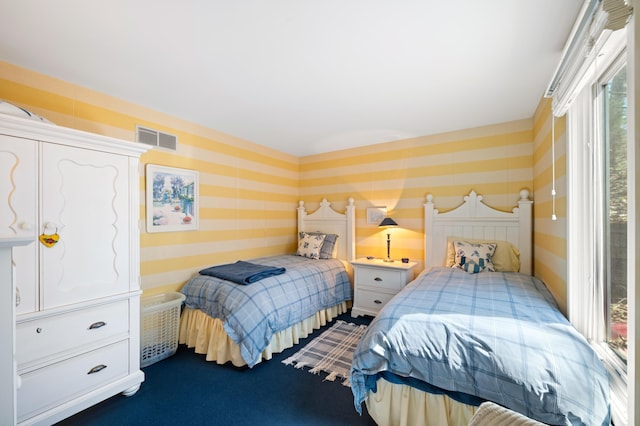 50102 Alpine Blvd, New Buffalo, MI 49117 - bedroom with wallpapered walls, dark carpet, and multiple windows