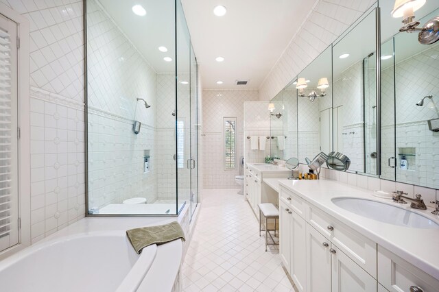 50102 Alpine Blvd, New Buffalo, MI 49117 - full bathroom featuring toilet, a shower stall, tile patterned floors, vanity, and tile walls
