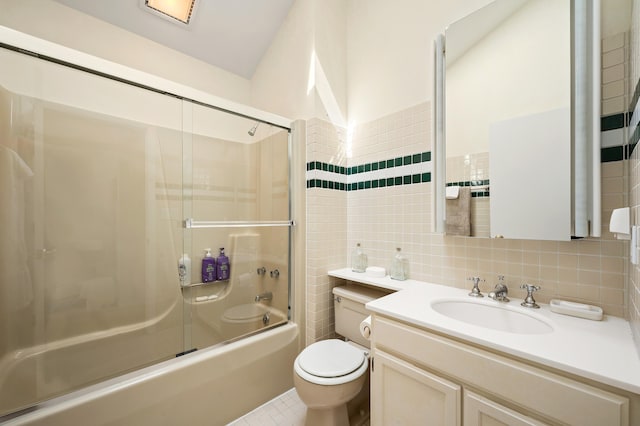 50102 Alpine Blvd, New Buffalo, MI 49117 - bathroom featuring tile walls, toilet, shower / bath combination with glass door, vanity, and tile patterned floors