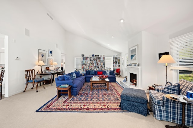 50102 Alpine Blvd, New Buffalo, MI 49117 - carpeted living area featuring a warm lit fireplace, baseboards, and high vaulted ceiling