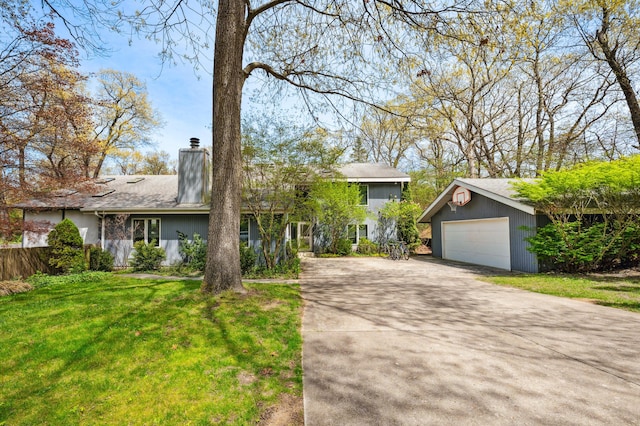50102 Alpine Blvd, New Buffalo, MI 49117 - view of front of home with an outbuilding, a chimney, a detached garage, and concrete driveway