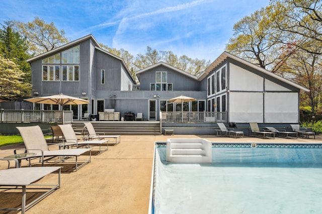 50102 Alpine Blvd, New Buffalo, MI 49117 - back of house featuring a wooden deck, an outdoor pool, a patio, and an outdoor living space
